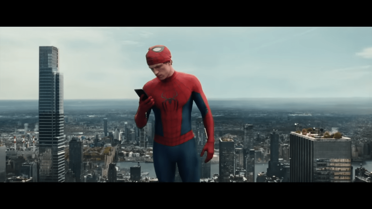 Peter Parker in his Spider-Man costume looking at his phone