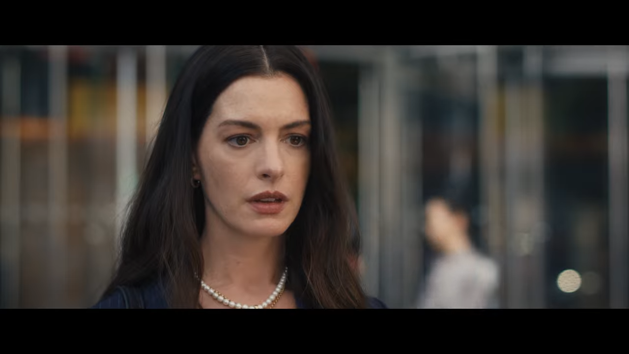 A woman stands on a busy street, giving off a sense of despair