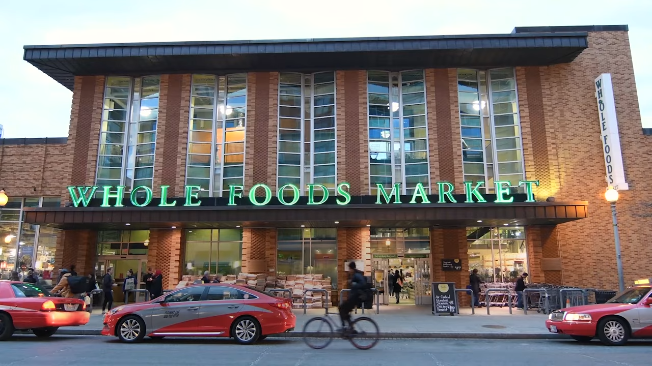 A Whole Foods storefront in a busy urban area
