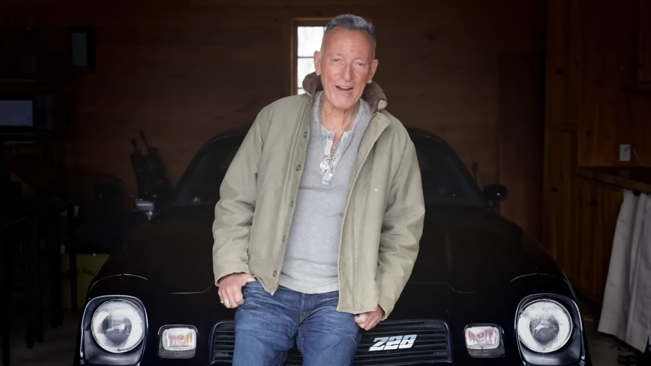 Bruce Springsteen relaxes in a garage, pitching tickets for an upcoming concert tour