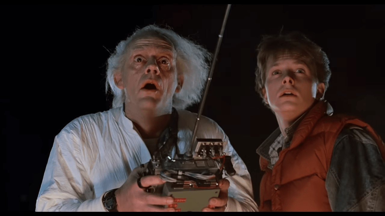 Christopher Lloyd standing beside Michael J. Fox in Back to the Future