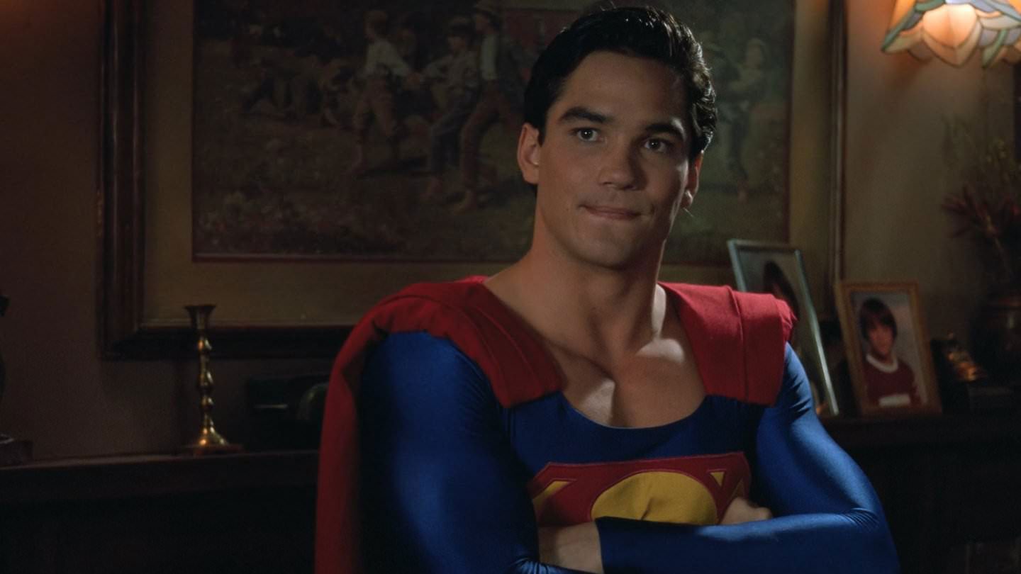 Superman stands with his arms crossed, determined