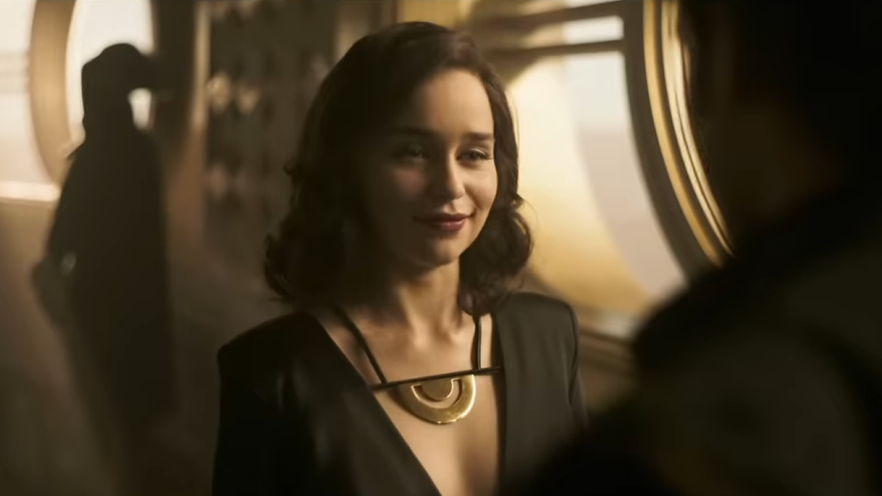 A young woman in a dress smirks at a former lover