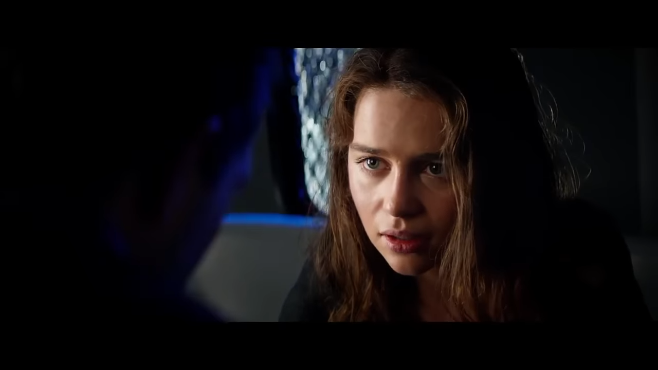 A young woman in a dark space, anxious