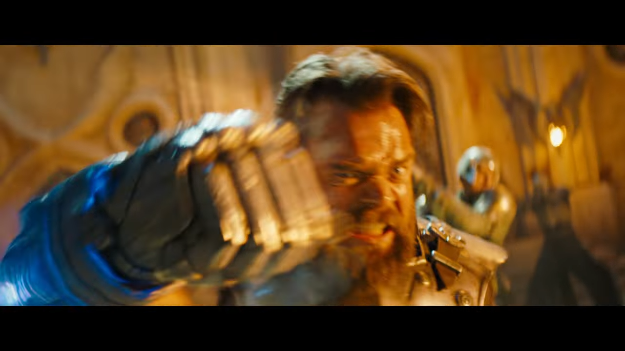 A wild-eyed, bearded man swings a punch