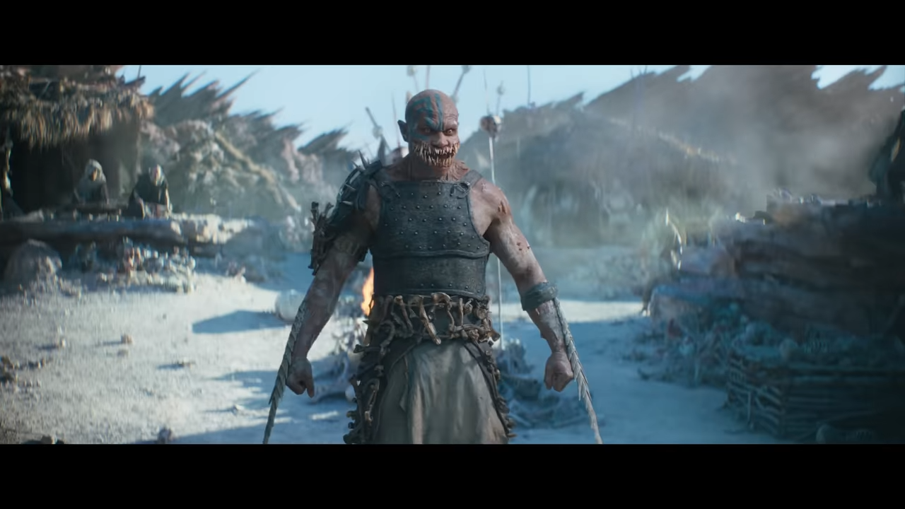 A threatening, human-like monster with a wide mouth and extra teeth stands with his arms at his sides