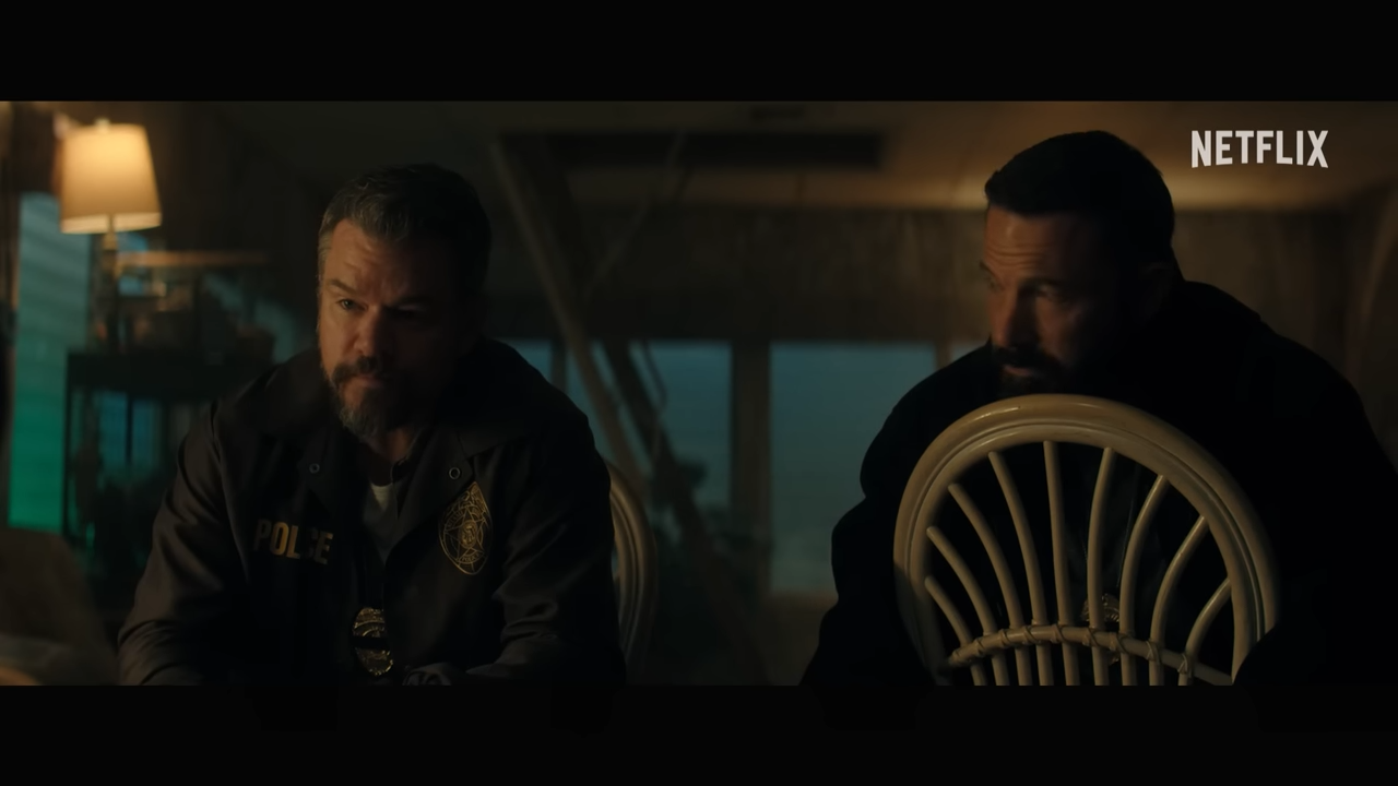 (42) The Rip Official Teaser Netflix 00-01-45 Two men sit side-by-side in a dark room, resting their chins the backs of their chairs