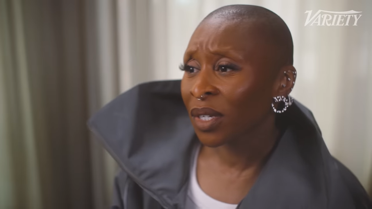 A black woman with a shaved head and septum ring looking unhappy
