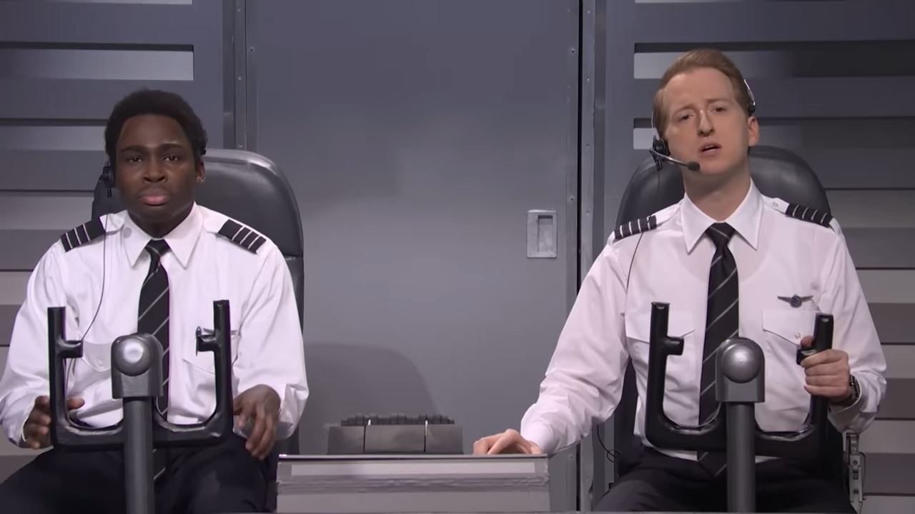 Two airline pilots in the cockpit for an SNL comedy sketch