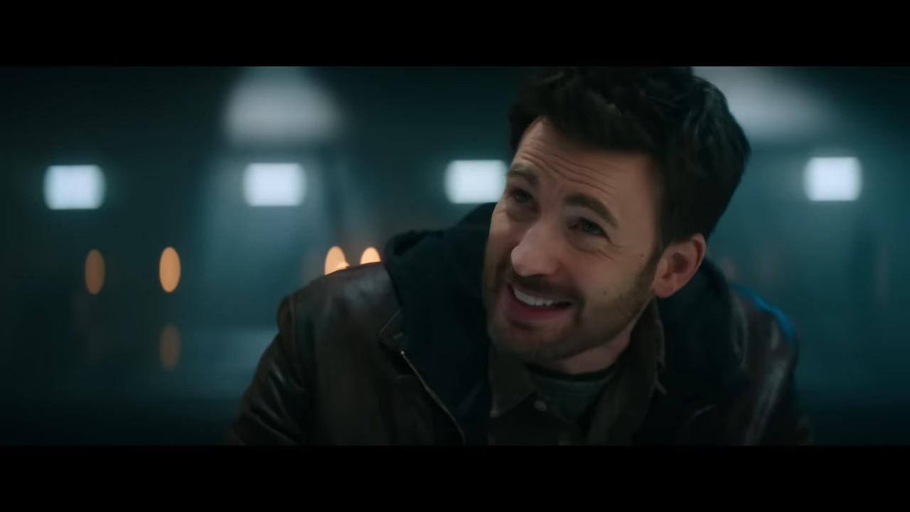 A bearded man smiles, but it seems like he's lying