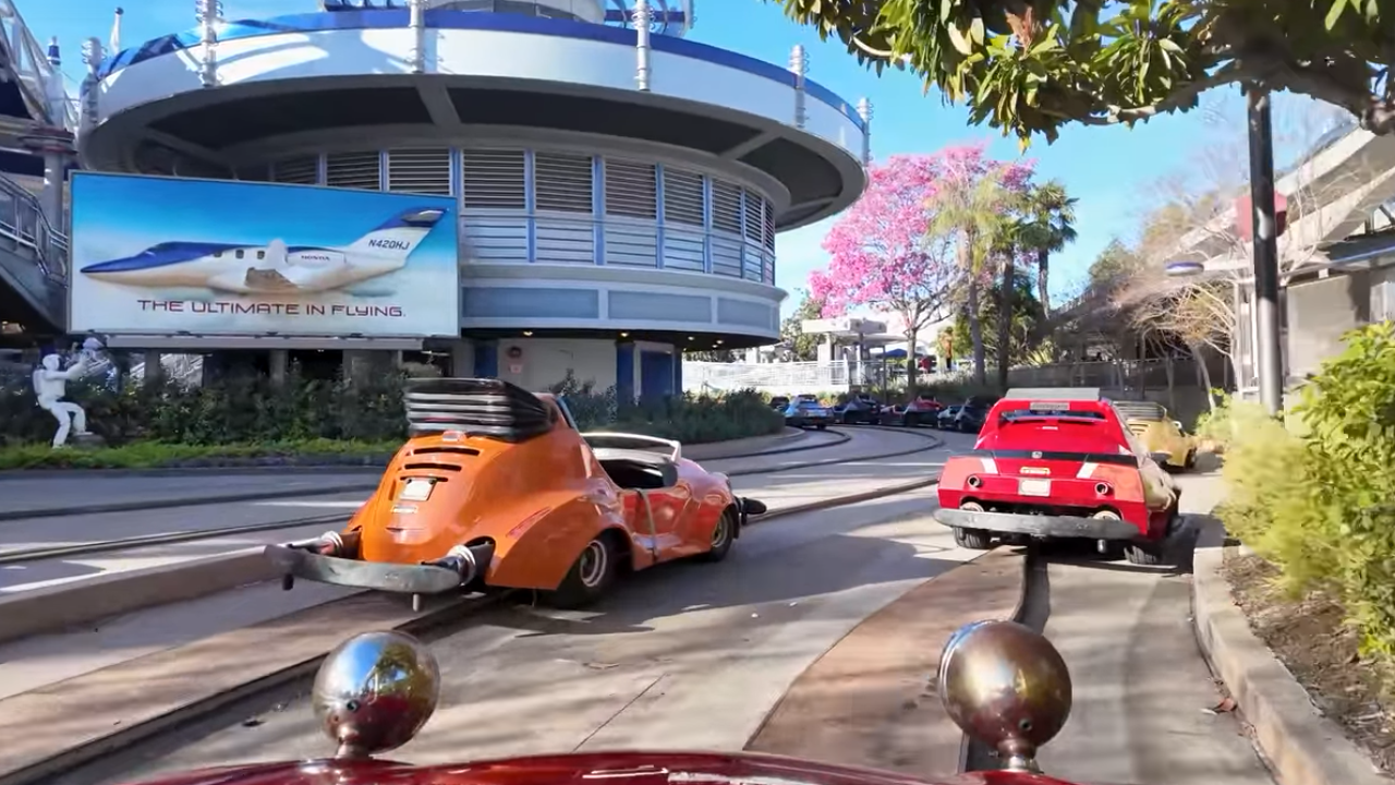 Autopia Disneyland tracks Orange and Red Car on the tracks of the Autopia at Disneyland