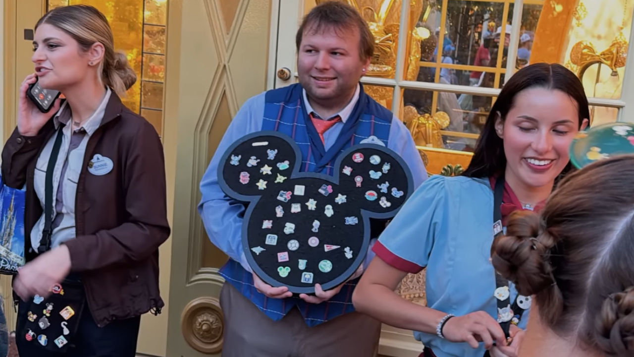 Cast Members with handheld pin boards and, pin bags, and pin lanyards