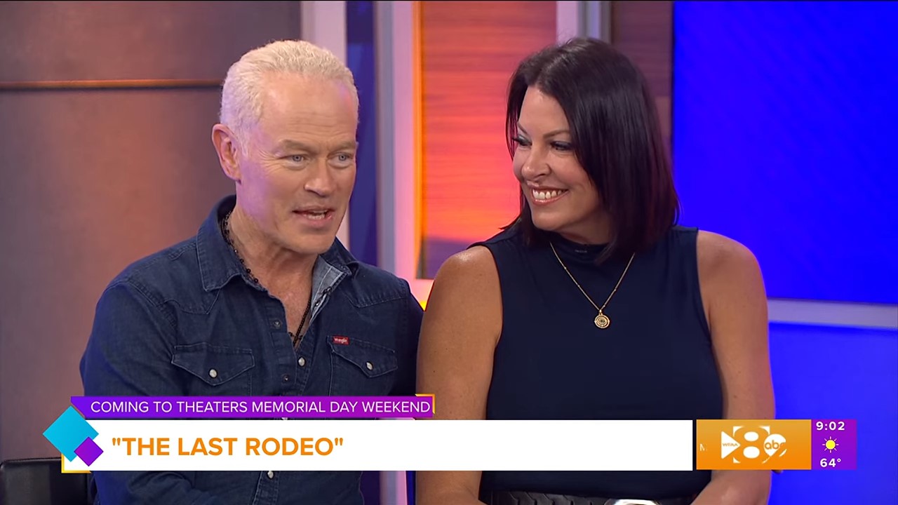 A couple on a TV morning show set for an interview talk happily