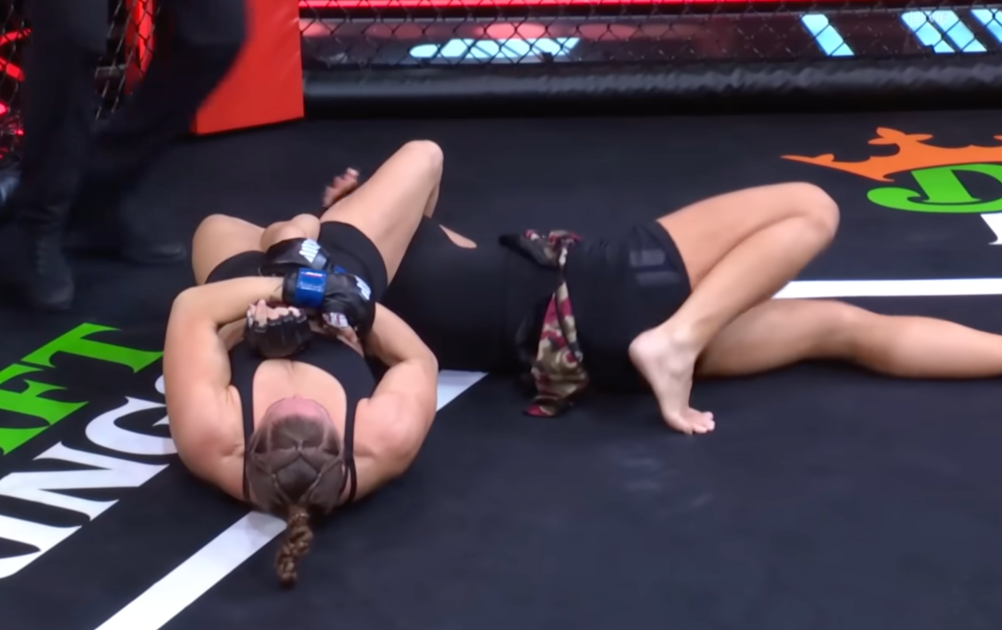 Ronda Rousey locks an arm bar on Gina Carano