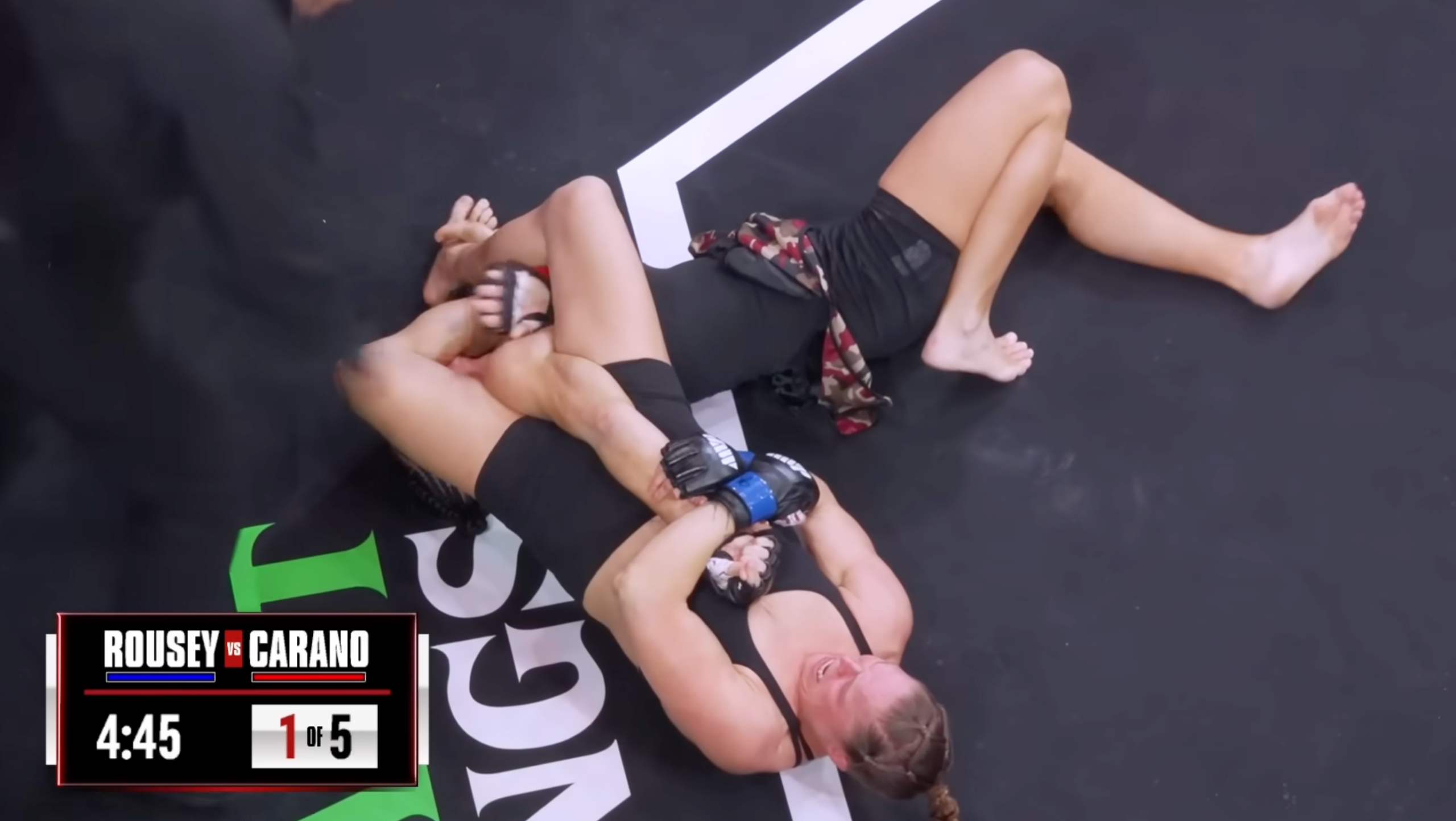 Gina Carano taps out to an armbar by Ronda Rousey