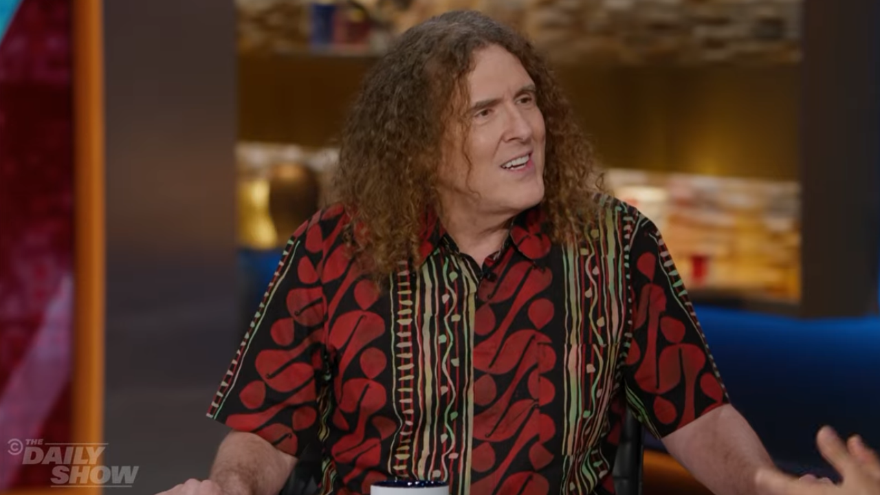 Weird Al Weird Al wearing a red and black shirt during an interview