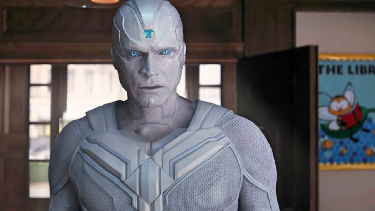 A white, human-like android with a blue stone in his forehead looks puzzled