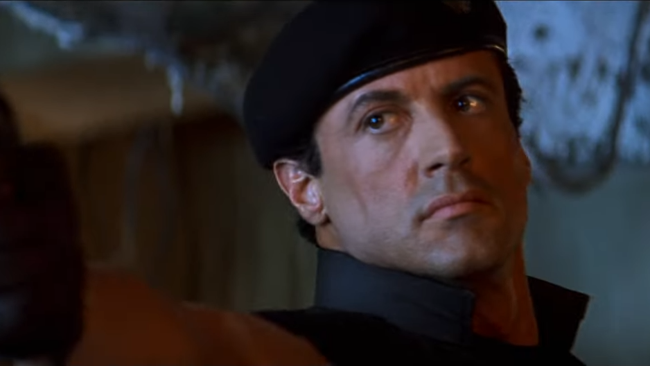 A man in a black beret looking very stern
