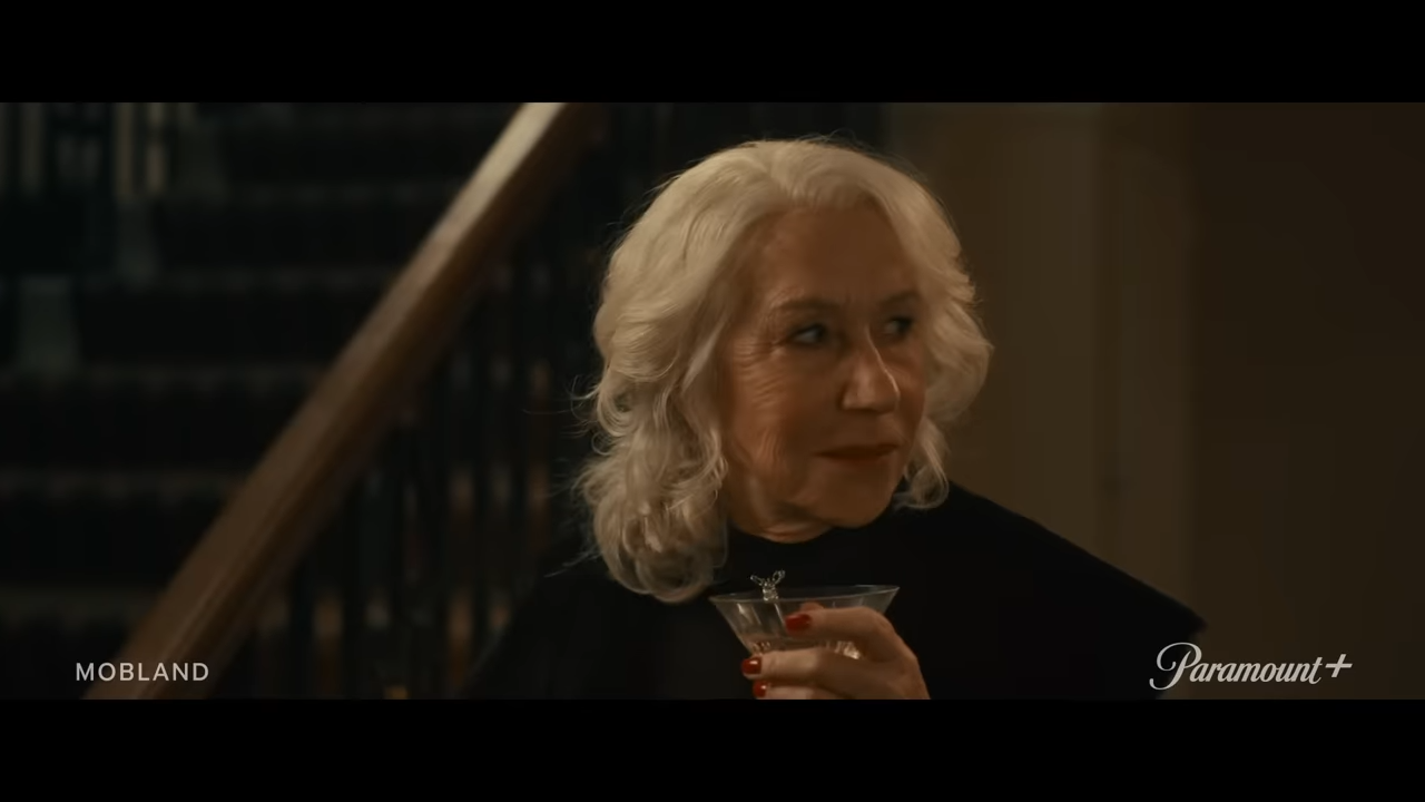 An elegant woman holds a drinking glass