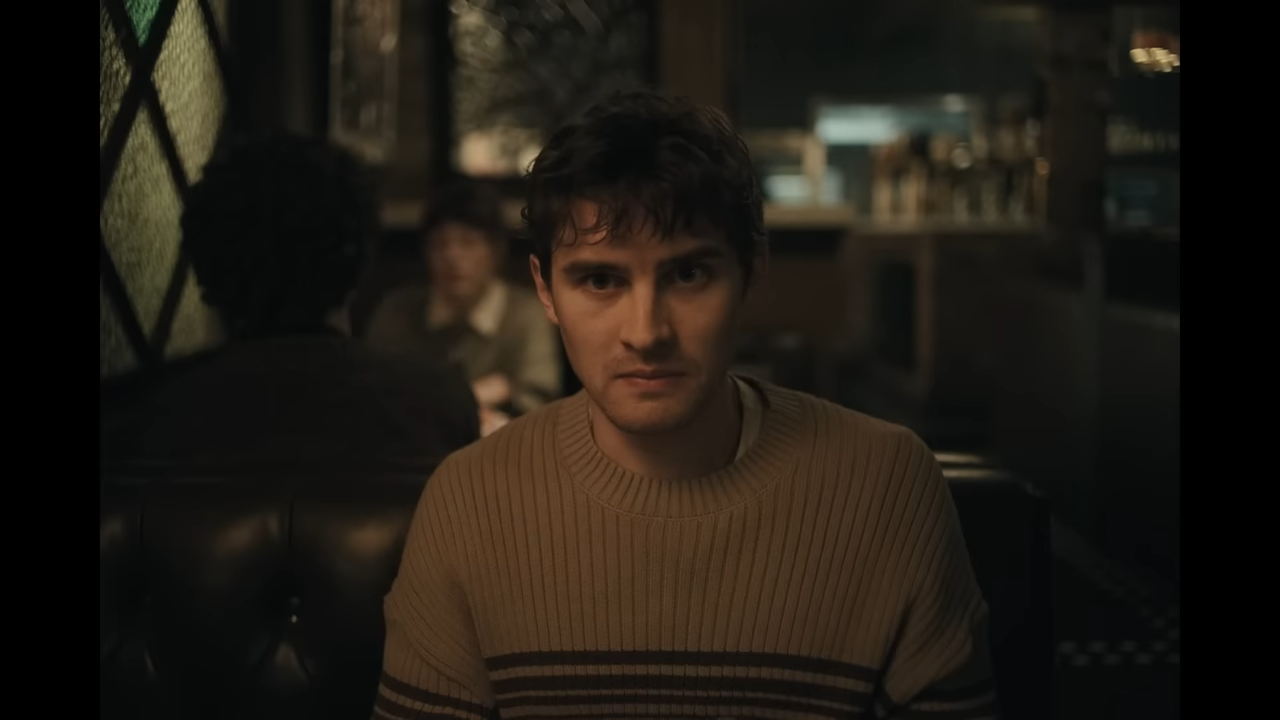 A young man, so nervous he appears sick, sits in a restaurant booth