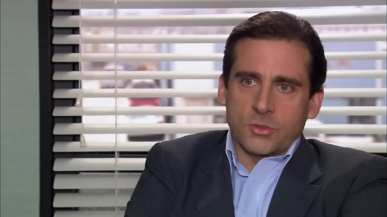 A man sits in front a window with open blinds, making an awkward confession