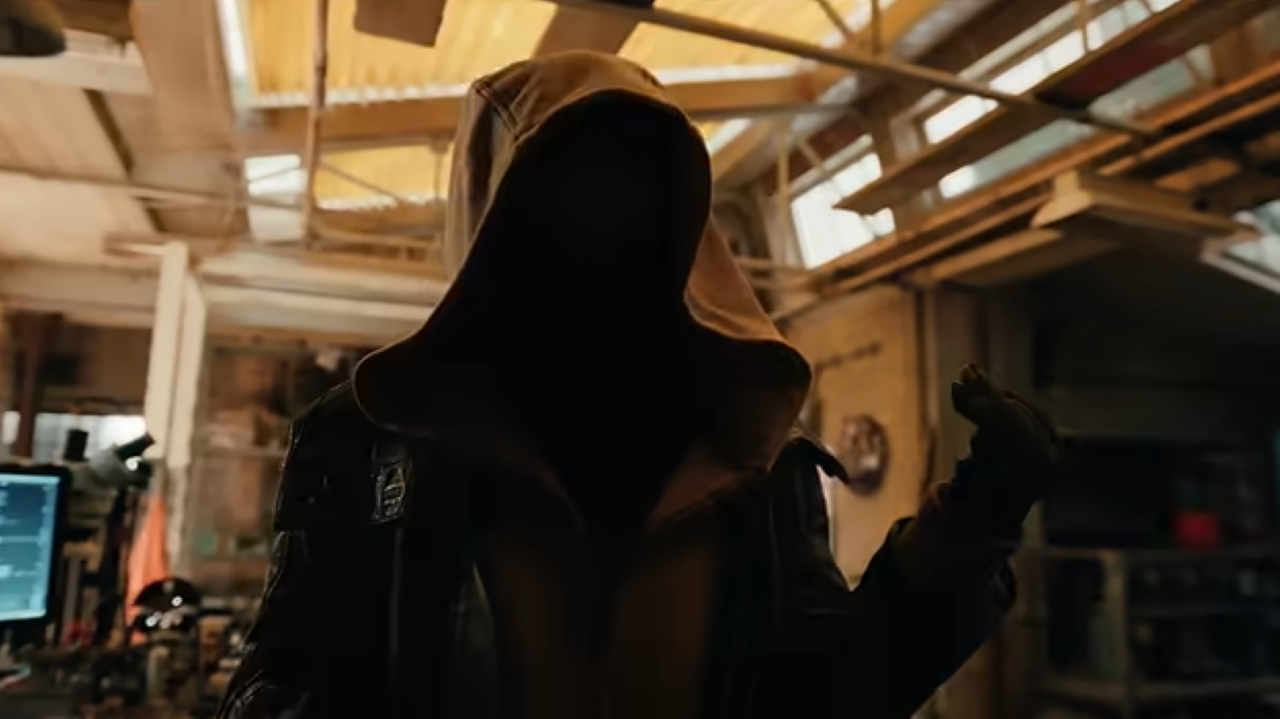 A hooded figure