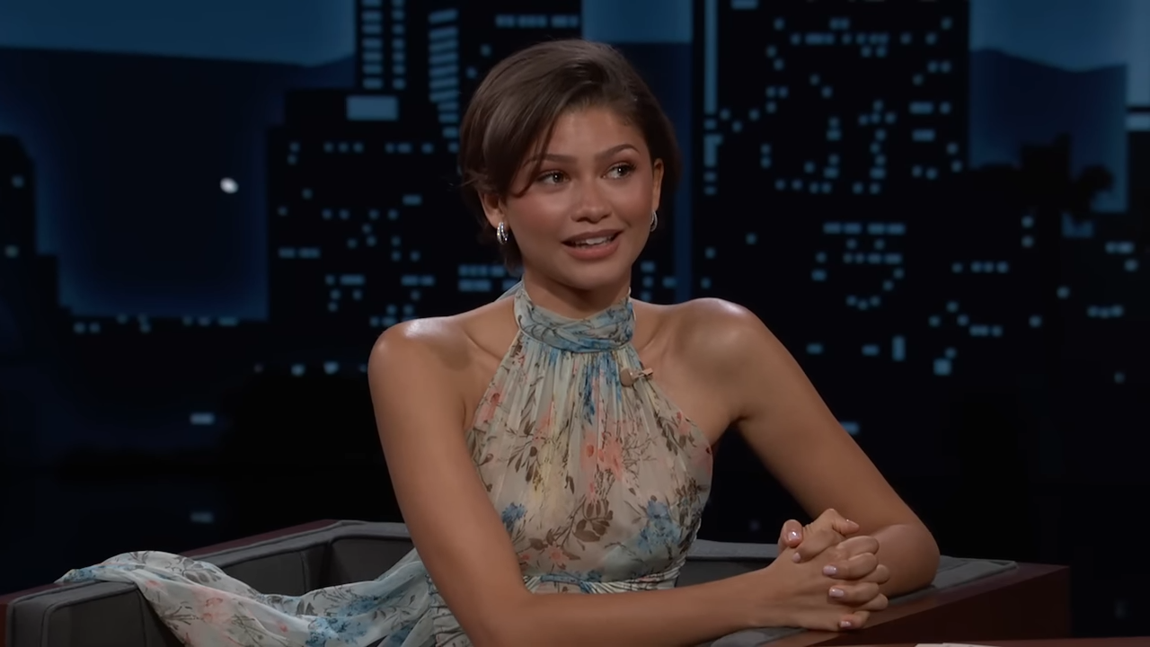 A young woman smiling during a late-night interview