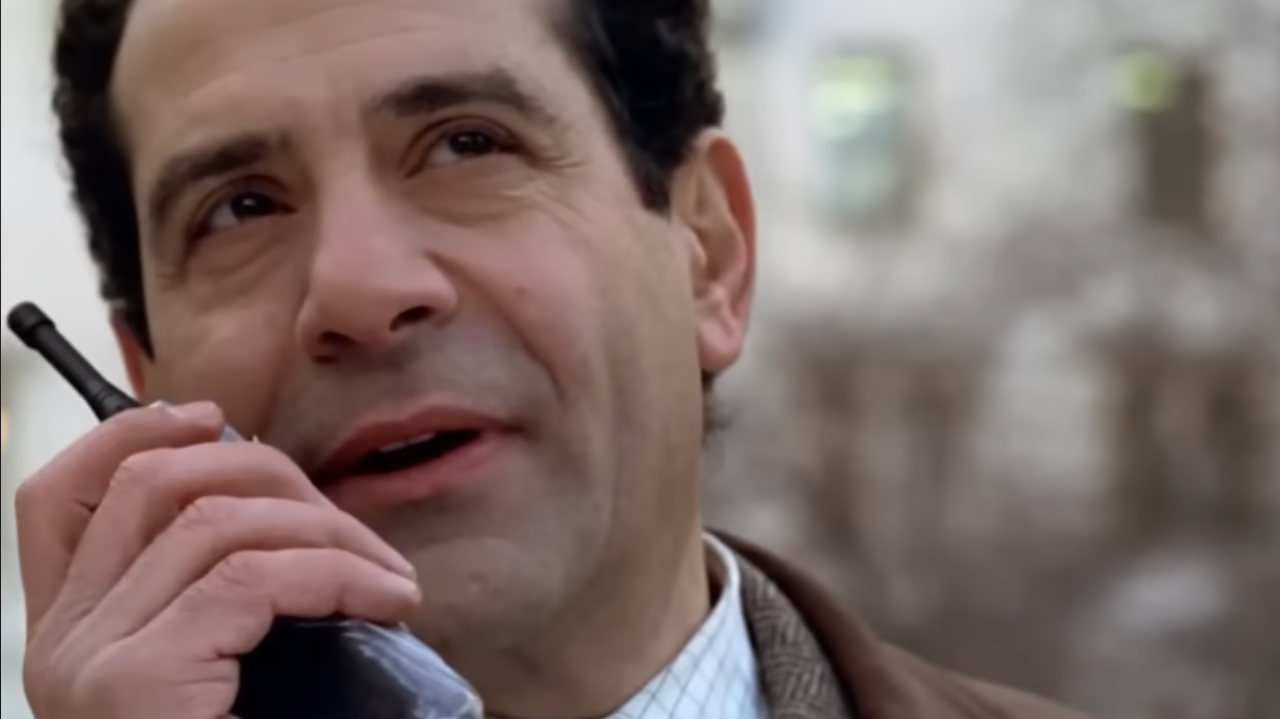 Close-up of Tony Shalhoub as Monk holding a walkie talkie