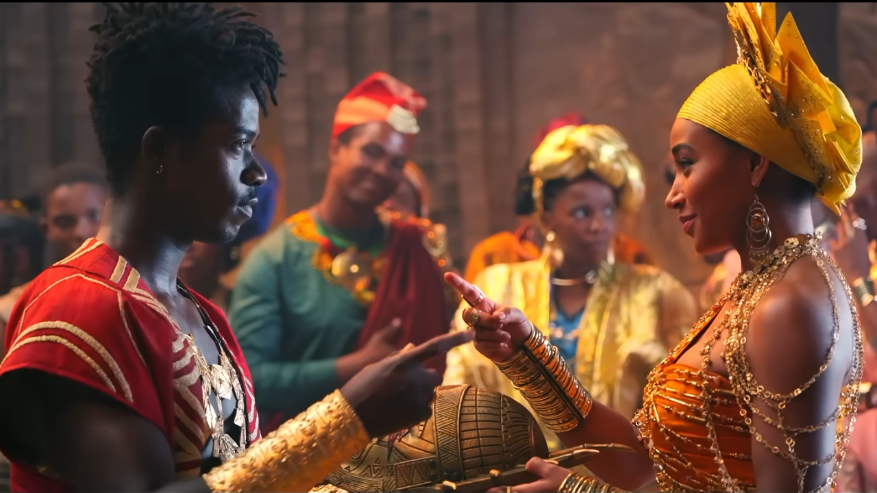 A young couple in traditional African clothes stare at one another