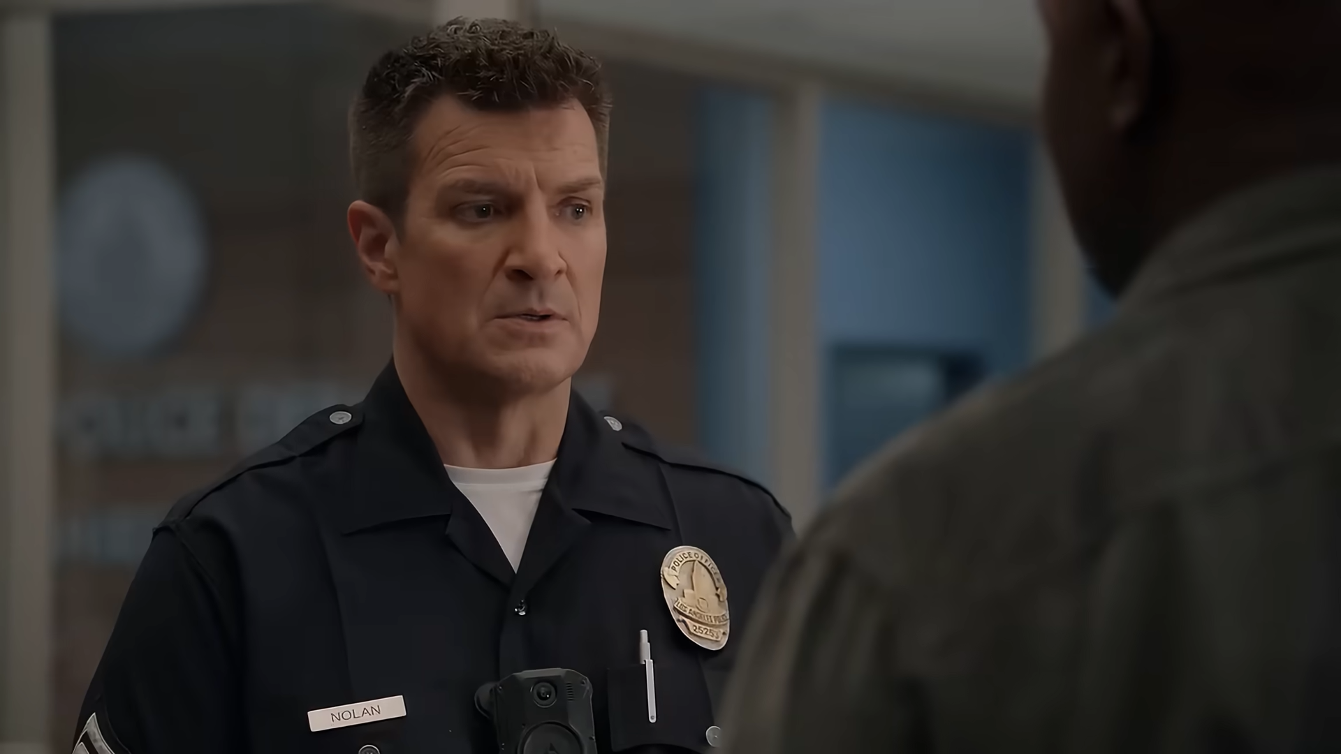 (124) The Rookie Season 8 Trailer (HD) Nathan Fillion series 00-01-38 A man in a police uniform looks thoughtful and uncomfortable