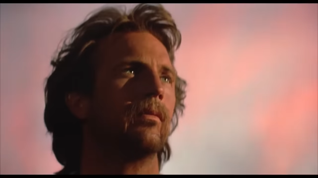 A frontiersman looks up at the setting sun