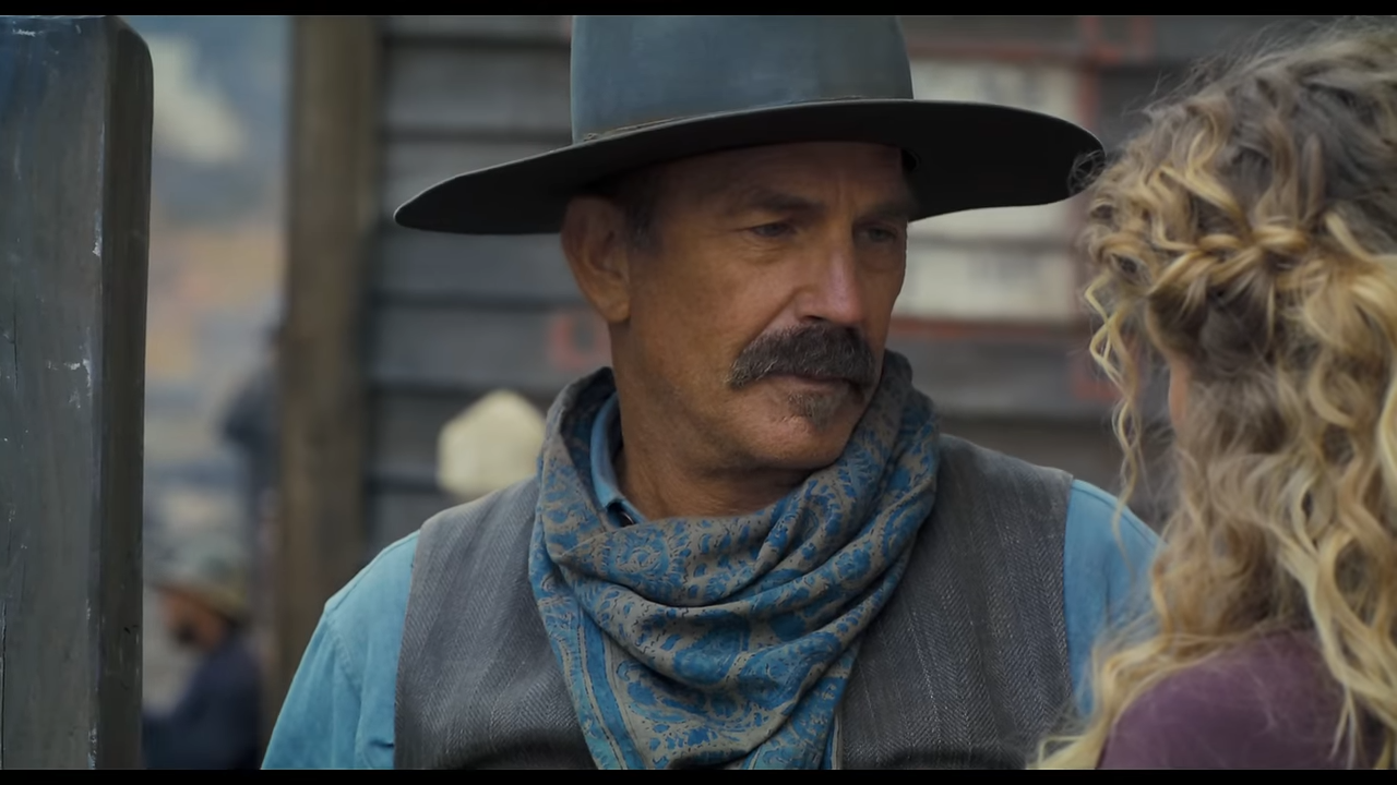 An older cowboy looks fondly at a woman