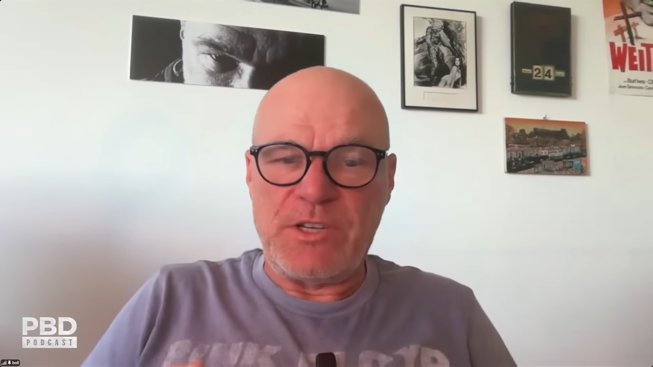 Uwe Boll speaking into a webcam from an office