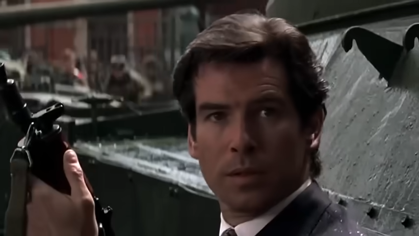 James Bond holding a rifle and looking alert