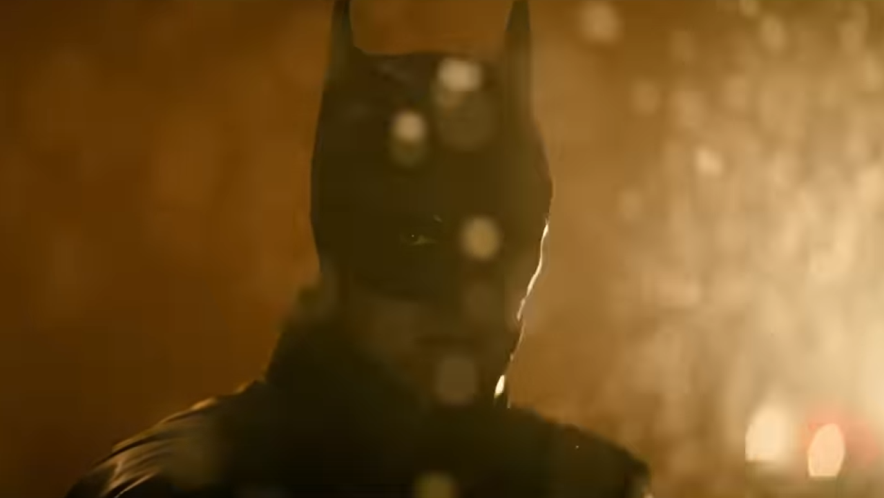 Batman glowers as snowflakes fall in front of his face