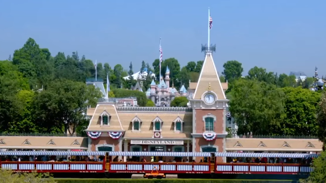 Train Station with train in front and Sleeping Beauty's Castle in the background