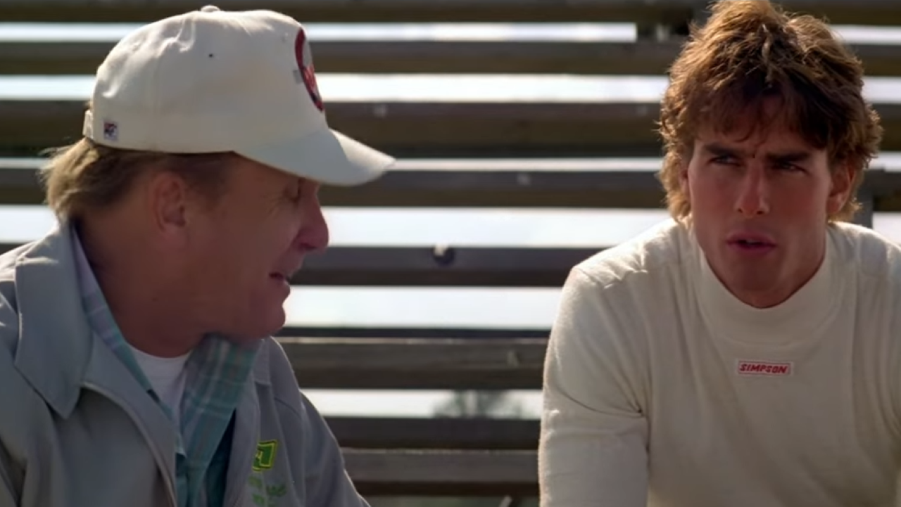 An older man sits beside a thoughtful younger man