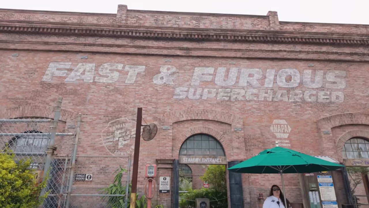 Brick building with faded white lettering "Fast & Furious Supercharged"