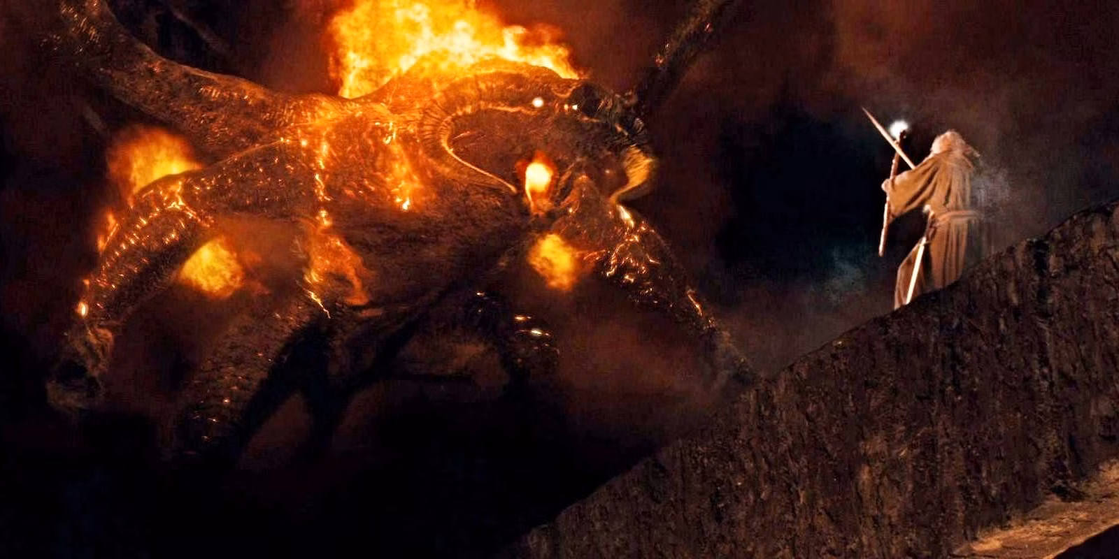 A wizard confronts a fire monster in a dark cave