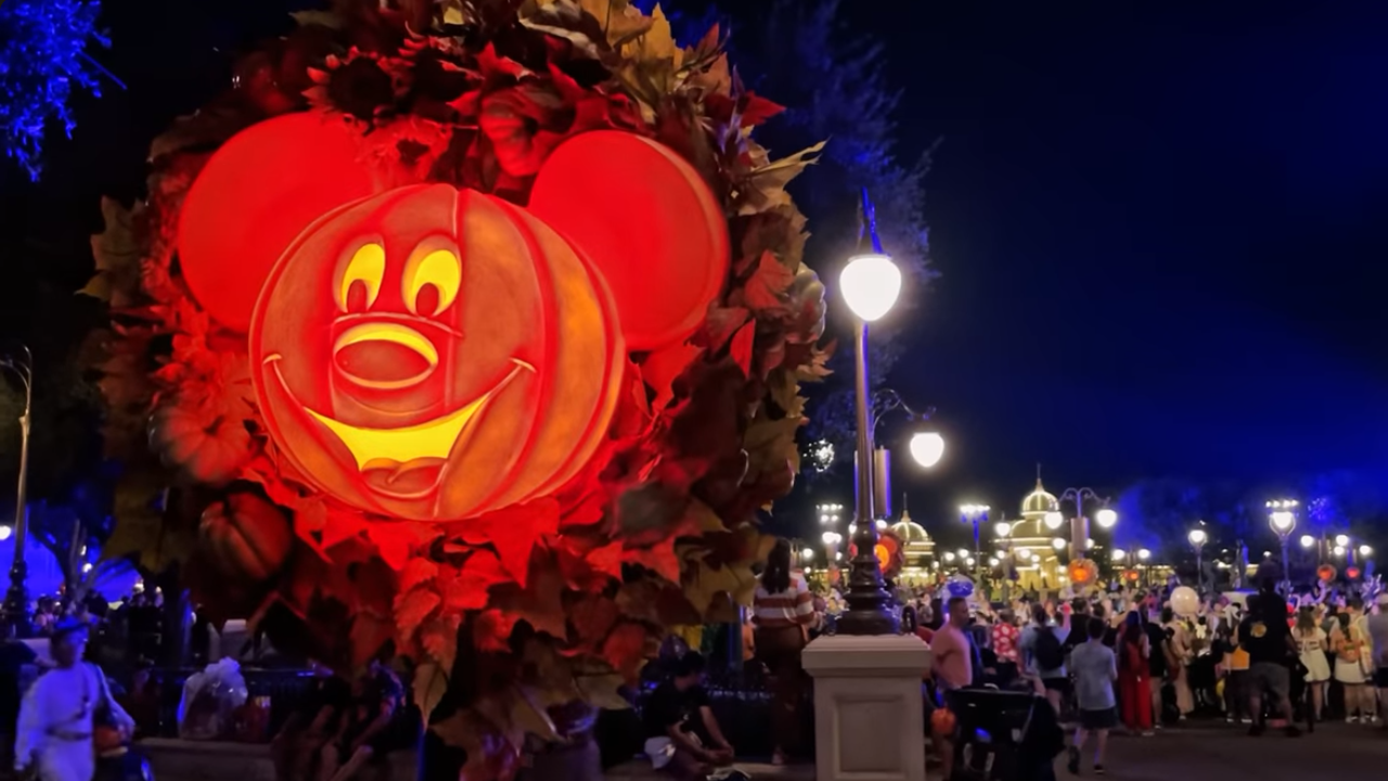 Halloween decor Magic Kingdom Glowing Mickey Jack-o-lantern in fall wreath at night