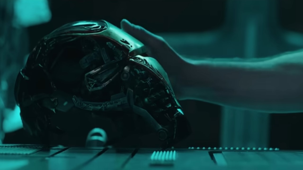 A hand rests on the side of the Iron Man helmet