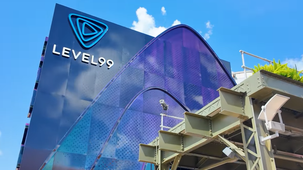LEVEL 99 exterior Tall blue glass building with purple accent structure