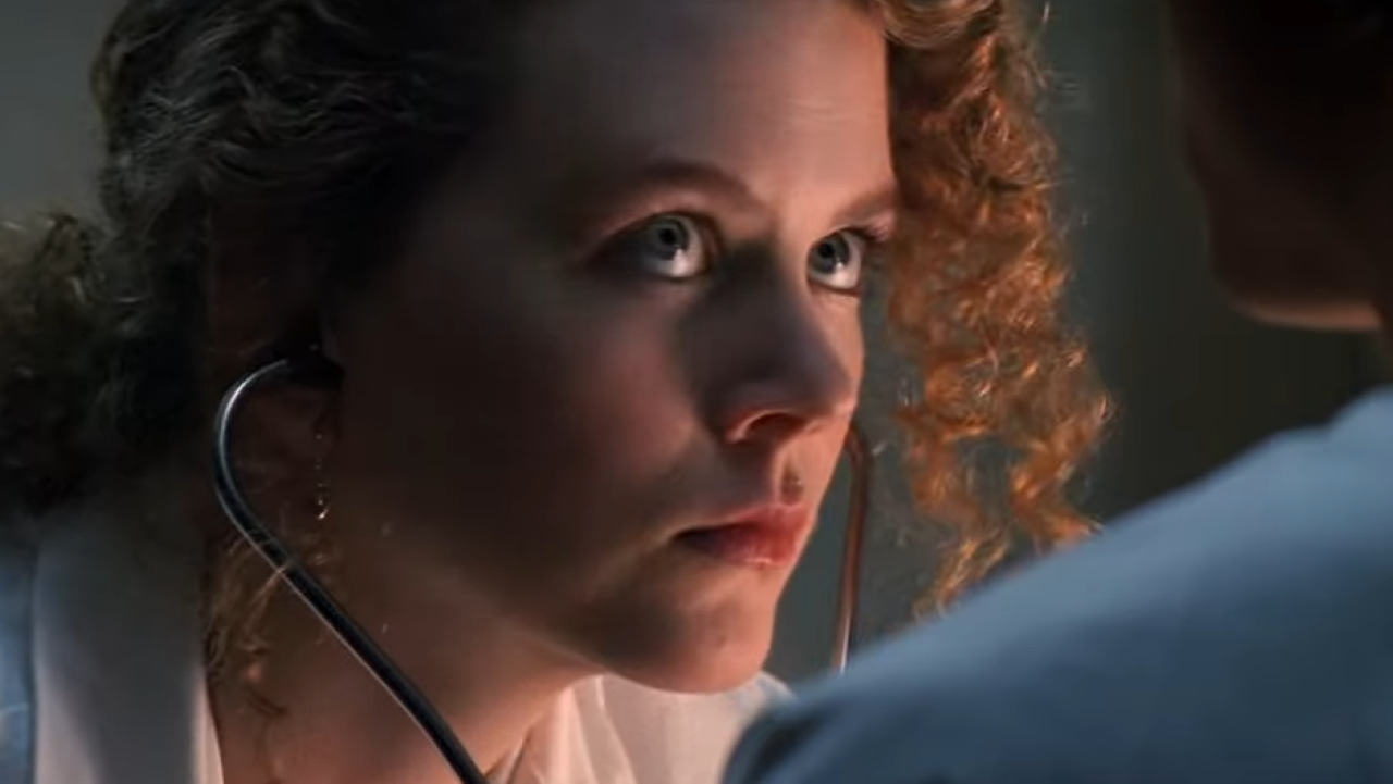 A serious woman with a stethoscope