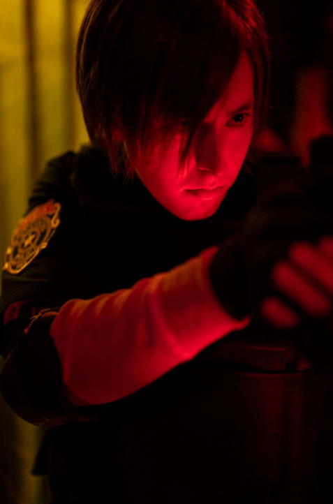 Close-up shot of man in police attire holding gun ready to shoot