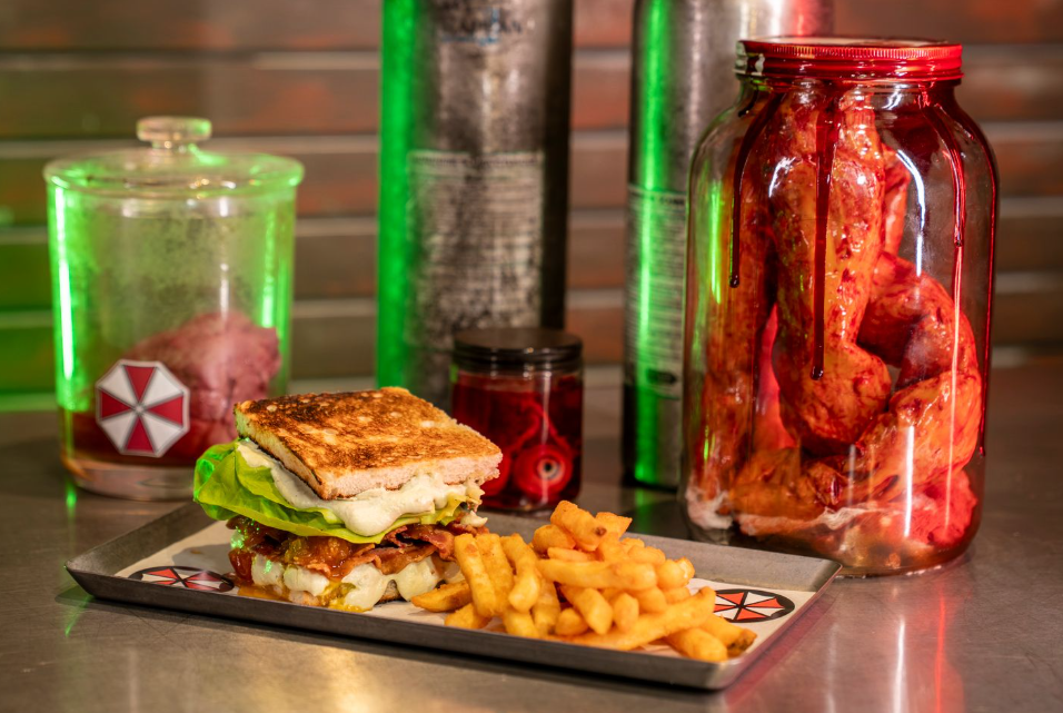 Sandwich and fries surrounded by prop experiments and body parts