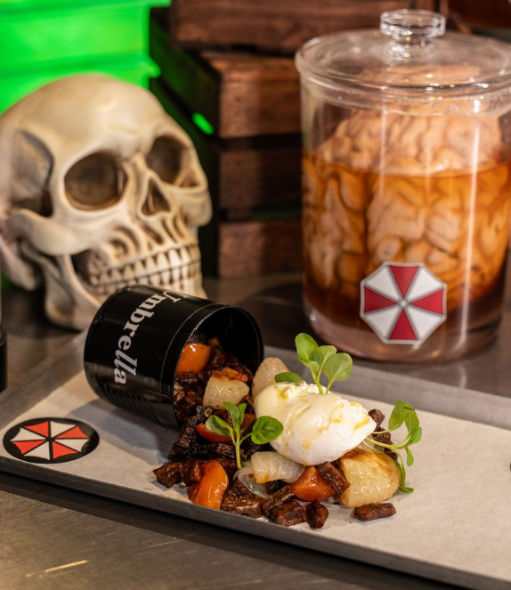 Food spilling out of miniature barrel surrounded by prop skull and brain
