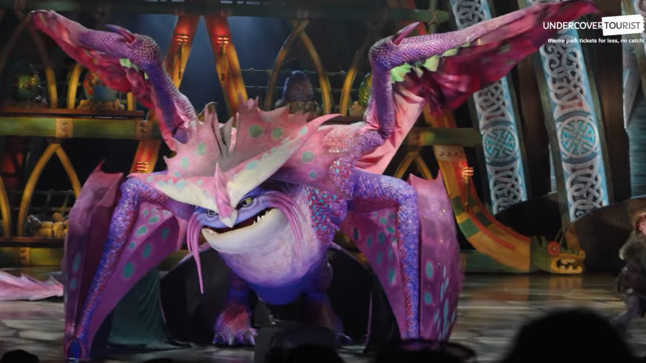 The Untrainable Dragon Epic Universe puppet Large pink-purple dragon with four wings dominating a stage