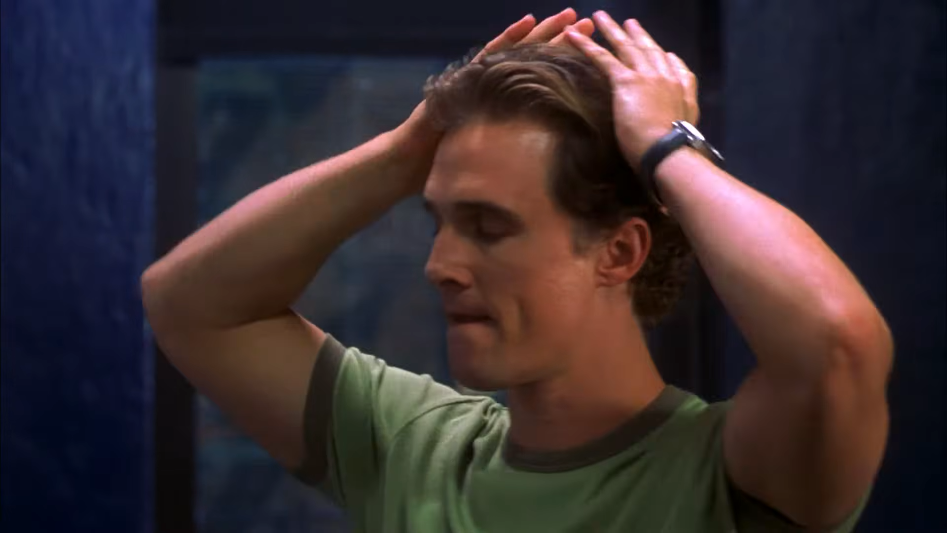 A man holds his head, exasperated