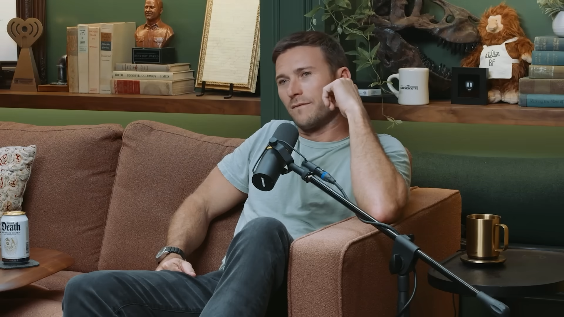A man sits comfortably in a chair, listening