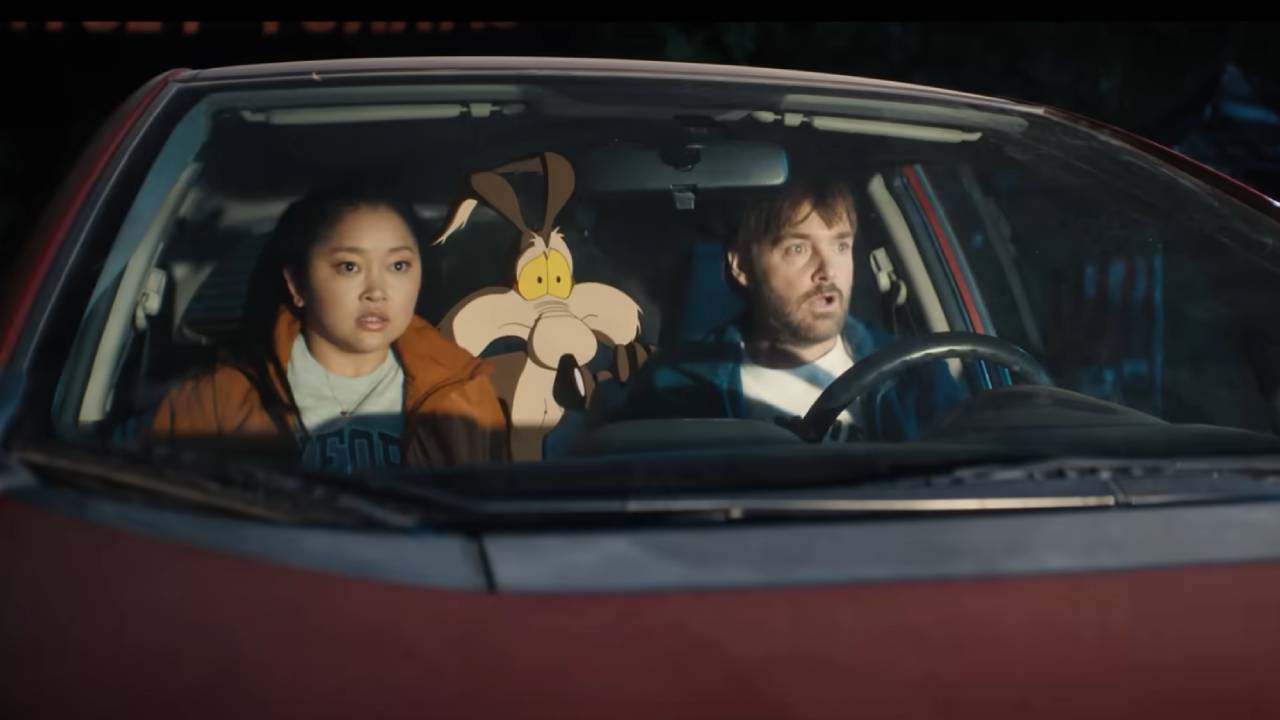 Wile E. Coyote, a man, and a woman sit in a car looking startled